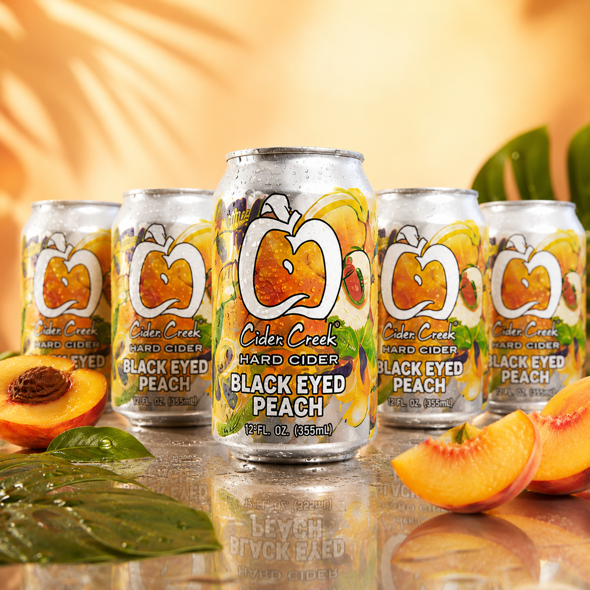 Black Eyed Peach hard cider cans with fresh peaches in a tropical setting