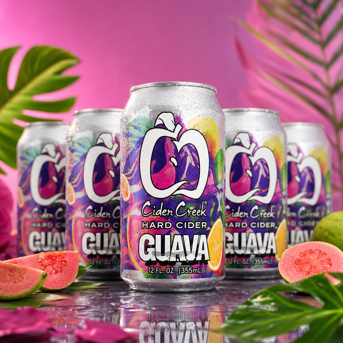 The Floor Is Guava hard cider cans with fresh guava in a tropical setting