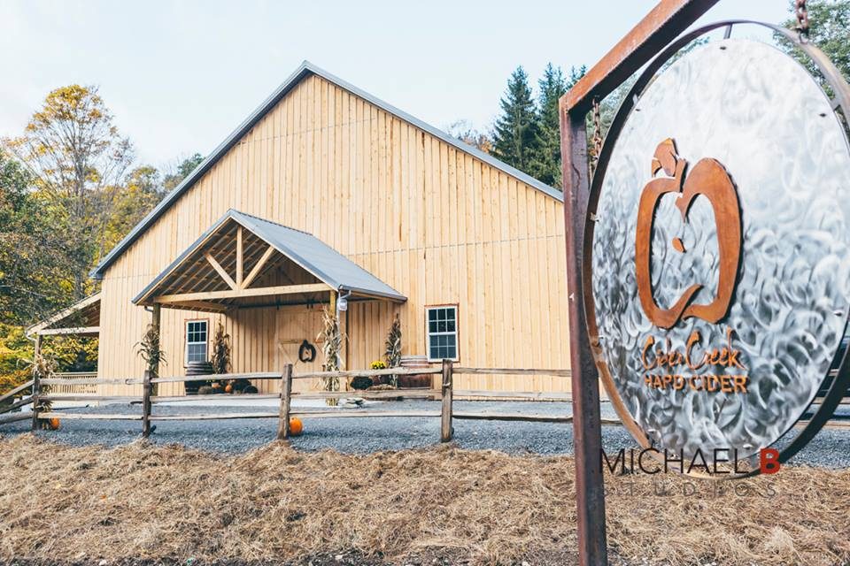 The Cider Creek barn in Canisteo, New York, with the metal apple sign out front